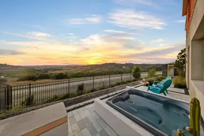 a hot tub on the balcony of a house with a view at Marbella Lane - Curated 5BR in Upscale RMV Haven in Ladera Ranch