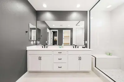 a bathroom with a white sink and a mirror at Marbella Lane - Curated 5BR in Upscale RMV Haven in Ladera Ranch