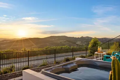a hot tub with a view of the mountains at Marbella Lane - Curated 5BR in Upscale RMV Haven in Ladera Ranch