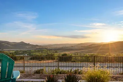 a view of a valley from a balcony with a fence at Marbella Lane - Curated 5BR in Upscale RMV Haven in Ladera Ranch