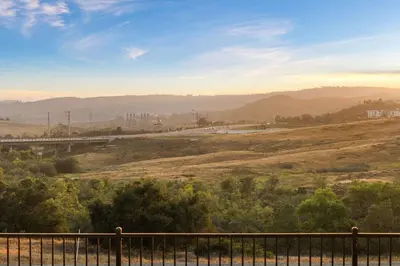 a view of a hill with a fence and trees at Marbella Lane - Curated 5BR in Upscale RMV Haven in Ladera Ranch