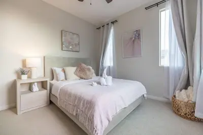a bedroom with a bed with a cat sitting on it at Marbella Lane - Elegant 5BR Home Rancho Mission in Ladera Ranch