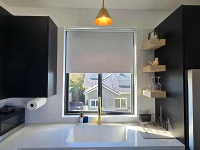 a kitchen with a large window and a white sink at Private Studio - Stylish Cozy & Central in San Diego