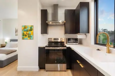 a kitchen with a sink and a stove top oven at Private Studio - Stylish Cozy & Central in San Diego