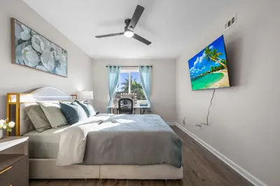 a bedroom with a bed and a ceiling fan at Entire Private Home with 4 Bedrooms 2 Bathrooms Garage, Pool, King Bed, Gated Yard in Rancho Penasquitos, Available Now in San Diego