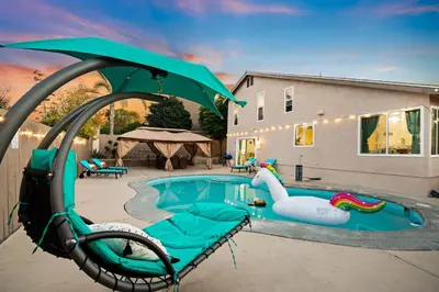 a swimming pool with a inflatable pool noodle pool at Entire Private Home with 4 Bedrooms 2 Bathrooms Garage, Pool, King Bed, Gated Yard in Rancho Penasquitos, Available Now in San Diego