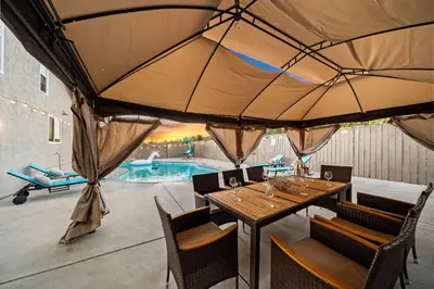 a patio with a table and chairs and a pool at Entire Private Home with 4 Bedrooms 2 Bathrooms Garage, Pool, King Bed, Gated Yard in Rancho Penasquitos, Available Now in San Diego