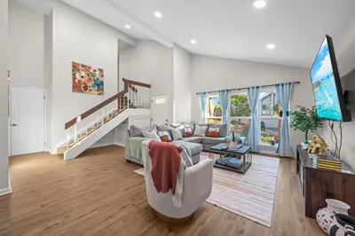 a living room with a couch and a tv at Entire Private Home with 4 Bedrooms 2 Bathrooms Garage, Pool, King Bed, Gated Yard in Rancho Penasquitos, Available Now in San Diego