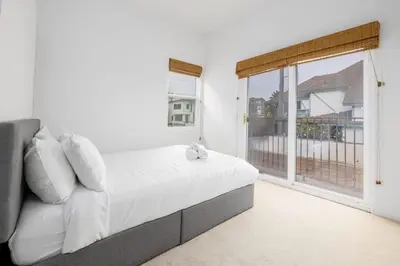 a bedroom with a bed and a large window at Ocean View 4 Bedroom Home in Carlsbad