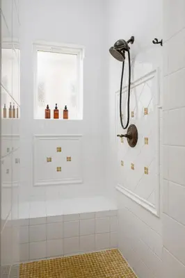 a white bathroom with a shower and a window at Ocean View 4 Bedroom Home in Carlsbad