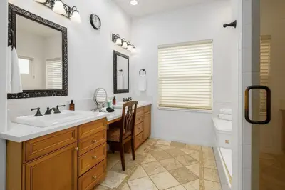 a bathroom with a sink and a mirror and a shower at Ocean View 4 Bedroom Home in Carlsbad