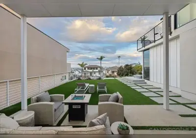 a patio with chairs and tables on a building at Luxurious Beach Master Suite in San Diego