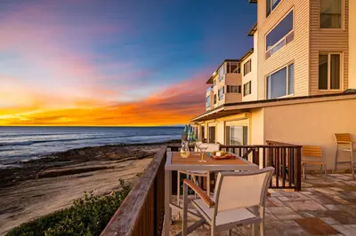 a house on the beach with a table and chairs at La Jolla Studio - Private Beach in San Diego