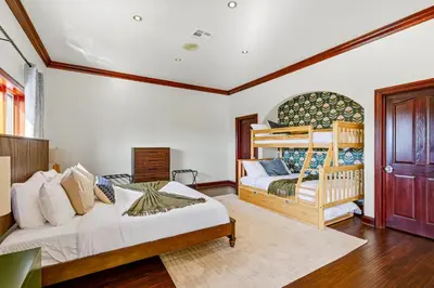 a bedroom with two beds and a bunk bed at Indoor Pool & Spa - Gym - Sauna - Pickleball Court in Perris