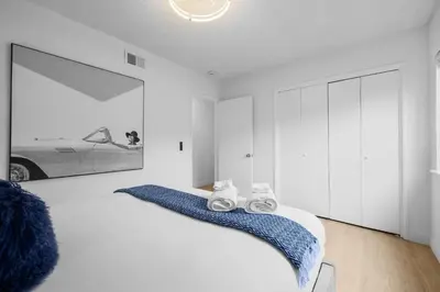 a bedroom with a bed with shoes on it at Ocean Paradise | Patio, Parking, BBQ, Location! in San Diego