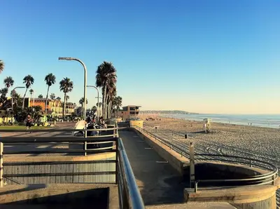 a beach with palm trees and a fence and the ocean at 1BR Close to Downtown SD, Beaches and North Park 1 in San Diego