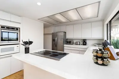 a kitchen with white cabinets and a white counter top at Spacious 4BD, La Jolla, Ocean Views, Jacuzzi in San Diego