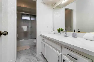 a white bathroom with a sink and a toilet at Spacious 4BD, La Jolla, Ocean Views, Jacuzzi in San Diego