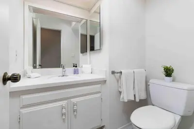 a white bathroom with a toilet and a sink at Spacious 4BD, La Jolla, Ocean Views, Jacuzzi in San Diego