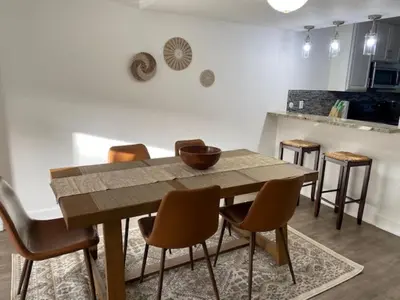 a dining room with a wooden table and chairs at Spanish Style San Diego Home Near Beaches in San Diego