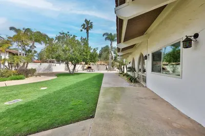 a driveway to a house with a green lawn at Spanish Style San Diego Home Near Beaches in San Diego