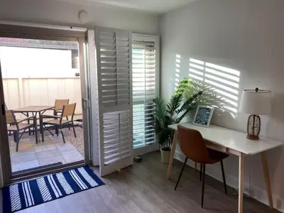 a room with a desk and a table and chairs at Spanish Style San Diego Home Near Beaches in San Diego
