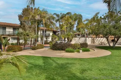a walkway through a park with palm trees at Spanish Style San Diego Home Near Beaches in San Diego