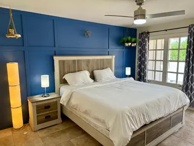 a bedroom with blue walls and a large bed at Private Pickleball Villa, Pool Oasis & Chic Casita in Fallbrook