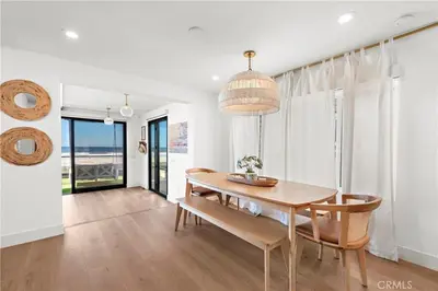 a dining room with a table and chairs at Beachfront Sunset in San Diego