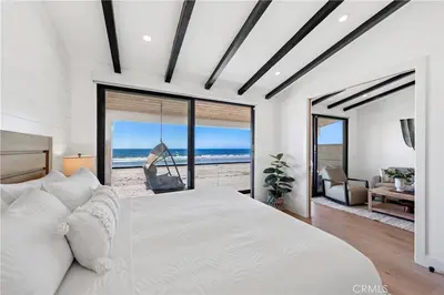 a bedroom with a bed and a swing at Beachfront Sunset in San Diego