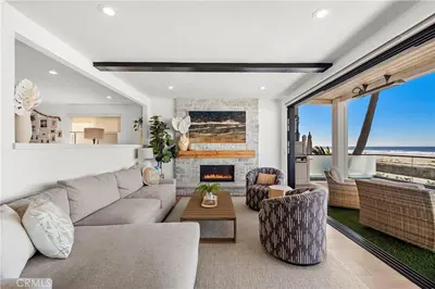 a living room with a couch and a fireplace at Beachfront Sunset in San Diego