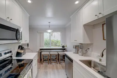 a kitchen with white cabinets and a counter top at La Jolla Lifestyle in San Diego