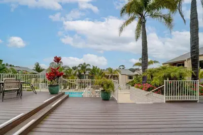 a wooden deck with palm trees and a pool at La Jolla Lifestyle in San Diego