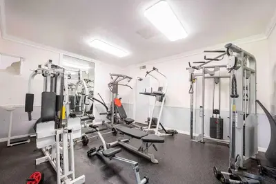 a gym with several tread machines in a room at Luxury Condo Resort Amenities - Pool, Pickleball in San Diego