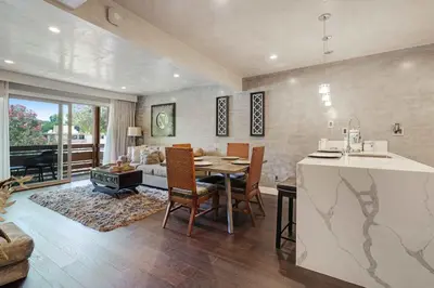 a kitchen and living room with a table and chairs at Luxury Condo Resort Amenities - Pool, Pickleball in San Diego