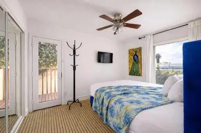 a bedroom with a bed and a ceiling fan at Central Location Cozy Home Villa in San Diego