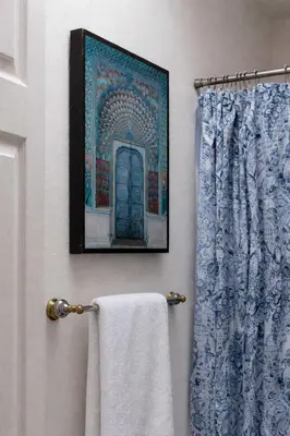 a bathroom with a towel and a picture on the wall at Central Location Cozy Home Villa in San Diego