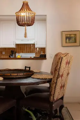 a dining room table with chairs and a chandelier at Central Location Cozy Home Villa in San Diego