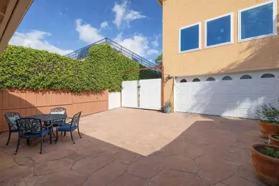 a patio with a table and chairs in front of a house at Central Location Cozy Home Villa in San Diego