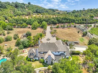 an aerial view of a house with a pool and trees at Casa Fuerte - Valley Estate w Pool Hot Tub Sports Court in Temecula
