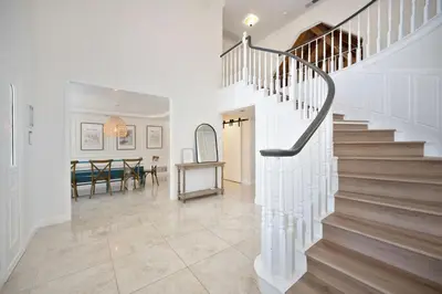 a white hallway with stairs and a dining room at Casa Fuerte - Valley Estate w Pool Hot Tub Sports Court in Temecula