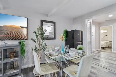 a dining room with a glass table and chairs at Entire Private Home with 2 Bedrooms 1 Bathroom, Gated Yard, Driveway Parking, Available Now in Spring Valley