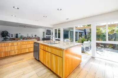a kitchen with a large island with a sink at Carlsbad Zen - Large Pool in Carlsbad