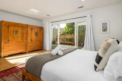 a bedroom with a large white bed and a window at Carlsbad Zen - Large Pool in Carlsbad