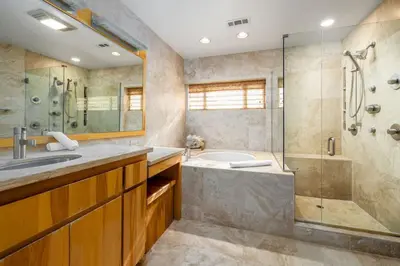 a bathroom with a tub and a shower and a sink at Carlsbad Zen - Large Pool in Carlsbad