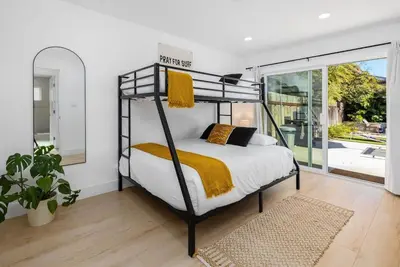 a bedroom with a bunk bed and a large window at Carlsbad Bungalow Large Backyard in Carlsbad