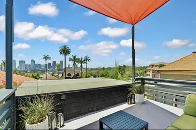 a patio with a swimming pool and an umbrella at The Downtown Carraige Flat in San Diego