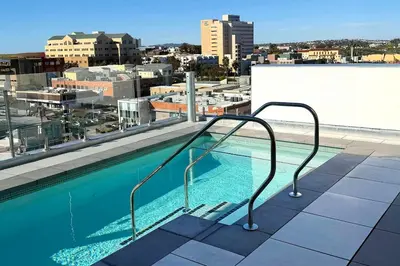 a swimming pool on the roof of a building at Luxury Designer Hillcrest Apartment with Pool & Gym in San Diego