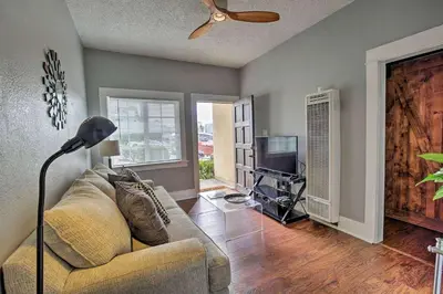 a living room with a couch and a television at Entire Building Sleeps 20 I Little Italy in San Diego