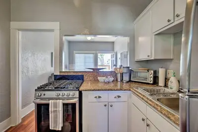 a kitchen with white cabinets and a stove top oven at Entire Building Sleeps 20 I Little Italy in San Diego